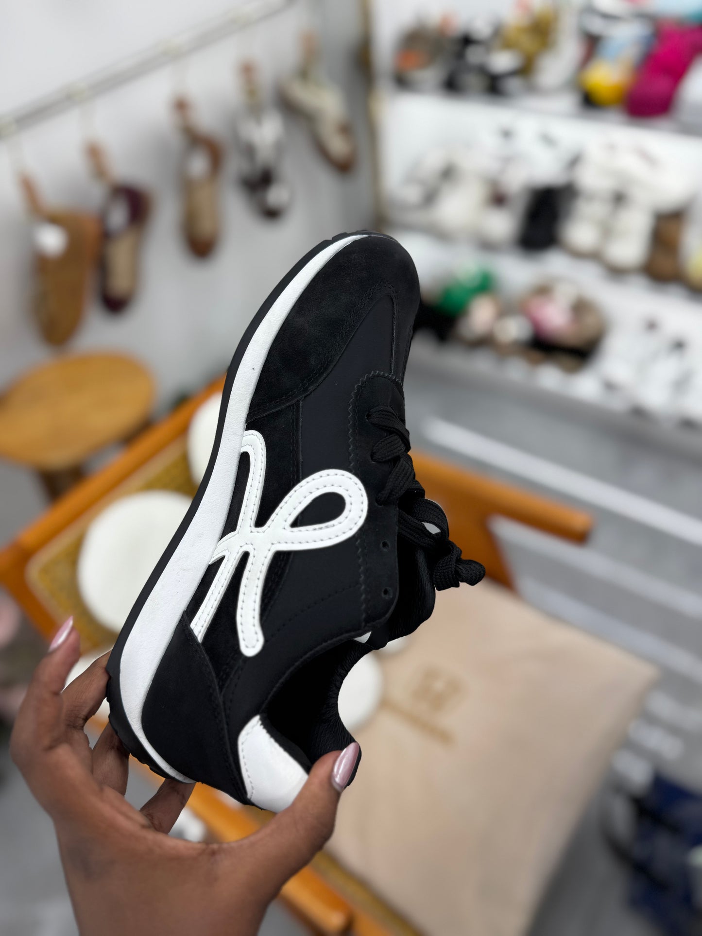 Black sneaker with white stripe