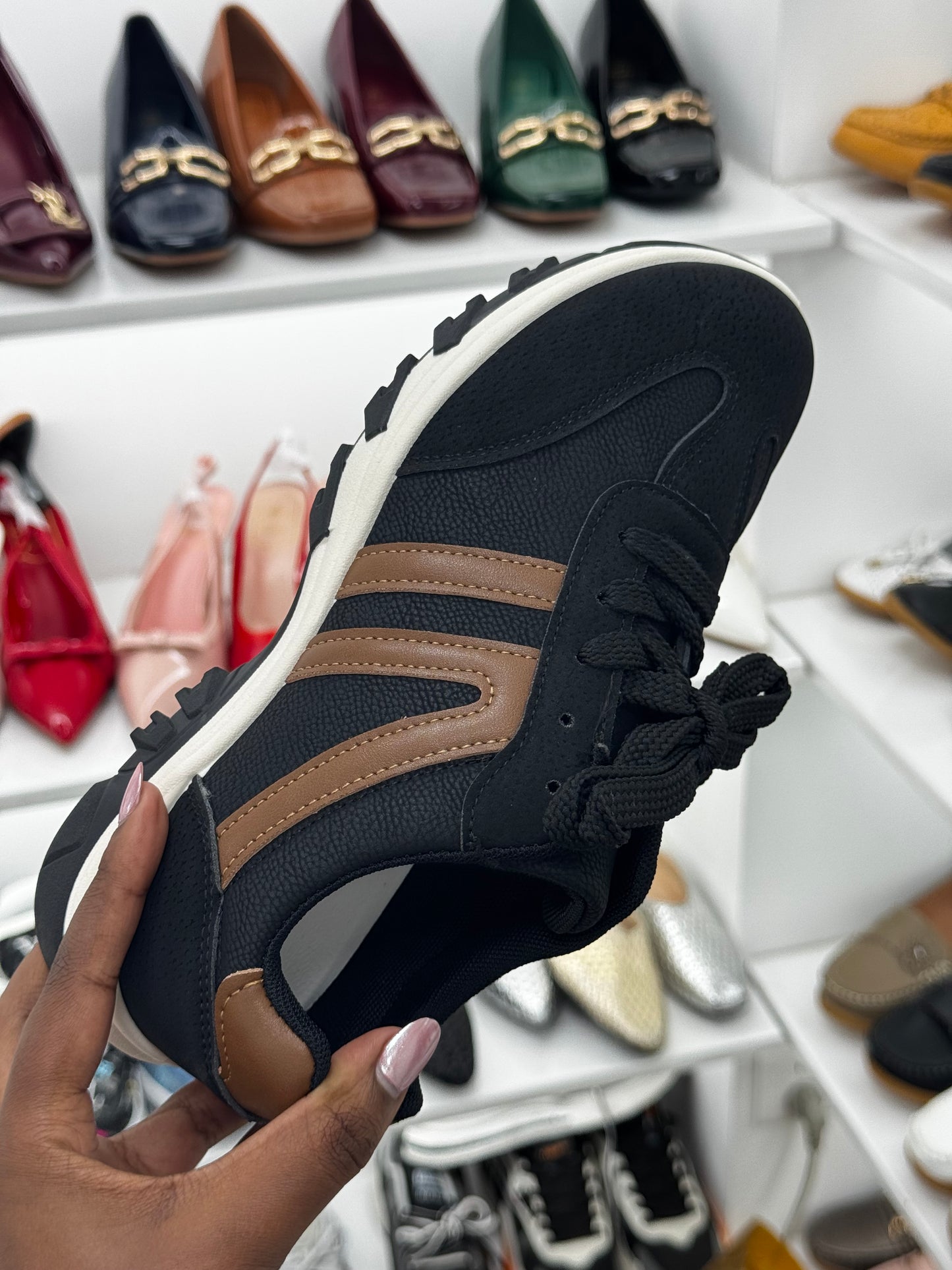 Black sneaker with brown stripes