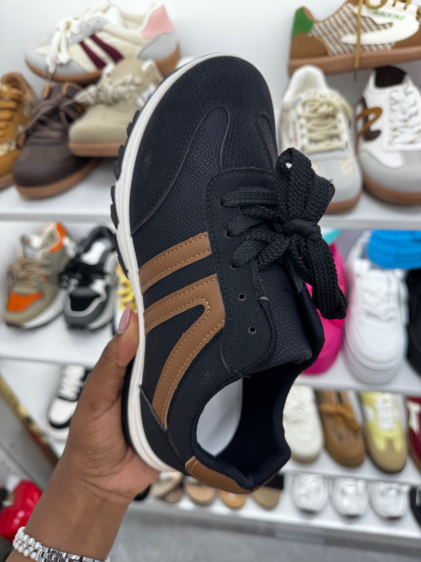 Black sneaker with brown stripes