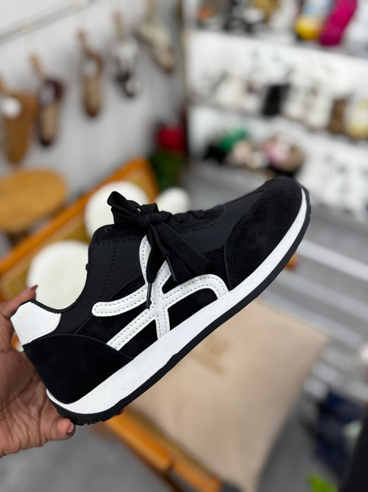 Black sneaker with white stripe